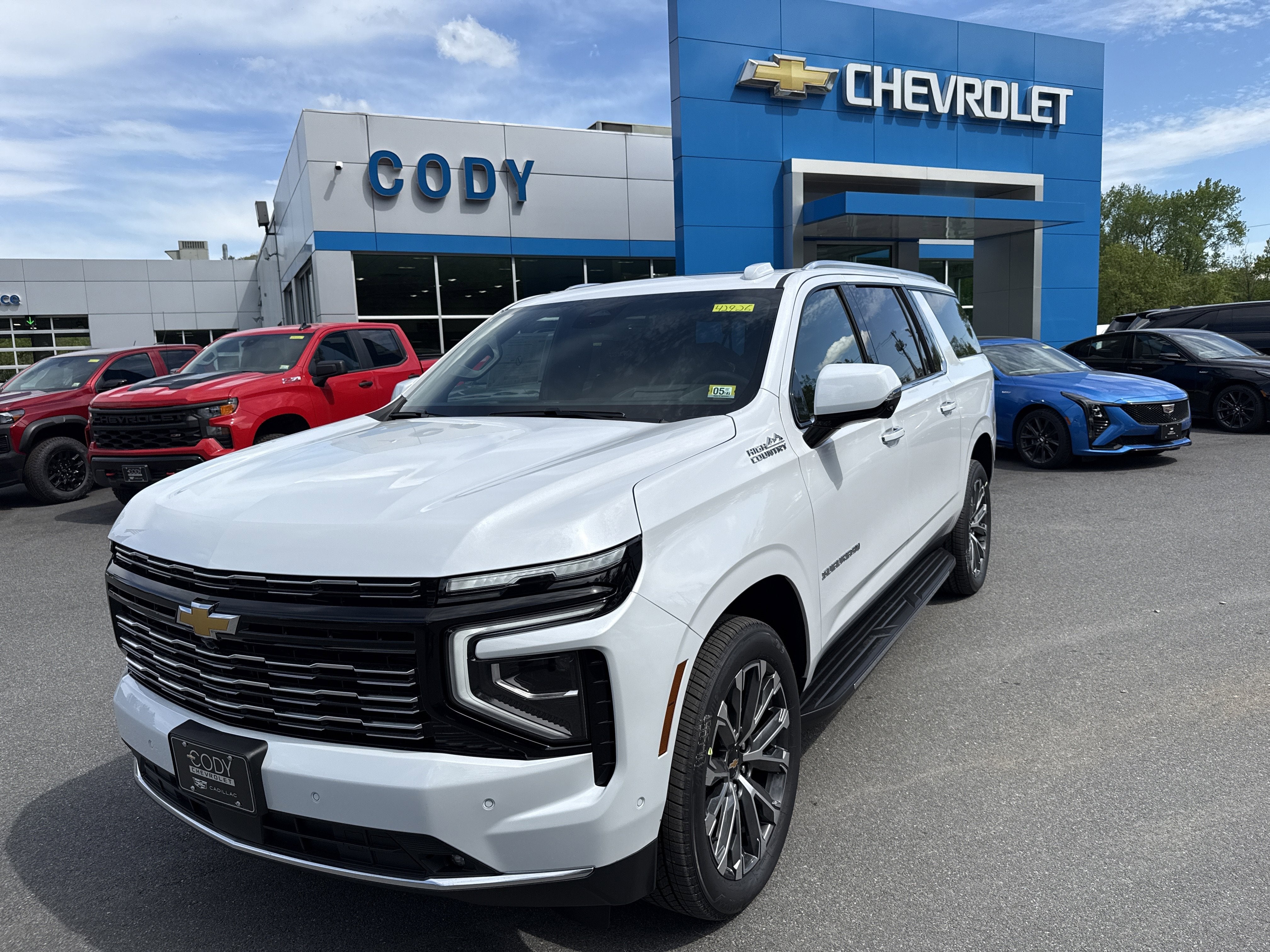 2026 Chevrolet Suburban High Country in Polar White Tricoat — front three-quarter view