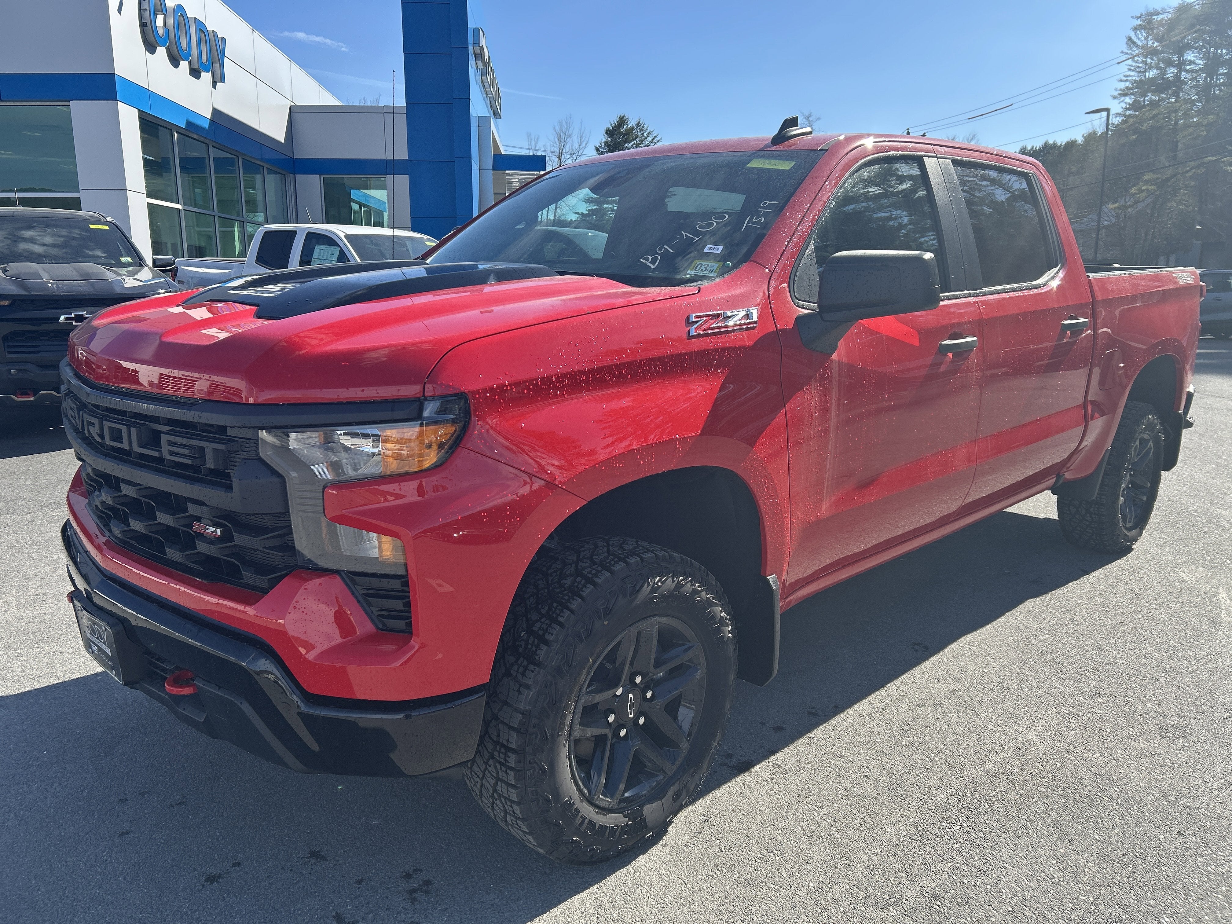 2026 Chevrolet Silverado 1500 Custom Trail Boss in Red Hot — front three-quarter view